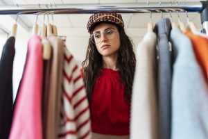 Sustainable fashion trends 2026 eco friendly clothing rack with neutral outfits and natural fabrics
