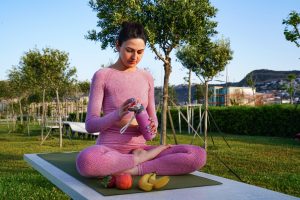 Healthy lifestyle habits concept with morning routine setup, journal, green smoothie, and yoga mat